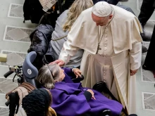 Pope Francis greets an elderly woman during his general audience Dec. 19, 2018.